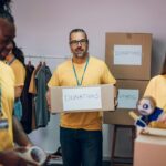 Group of multiracial volunteers working in community charity donation center