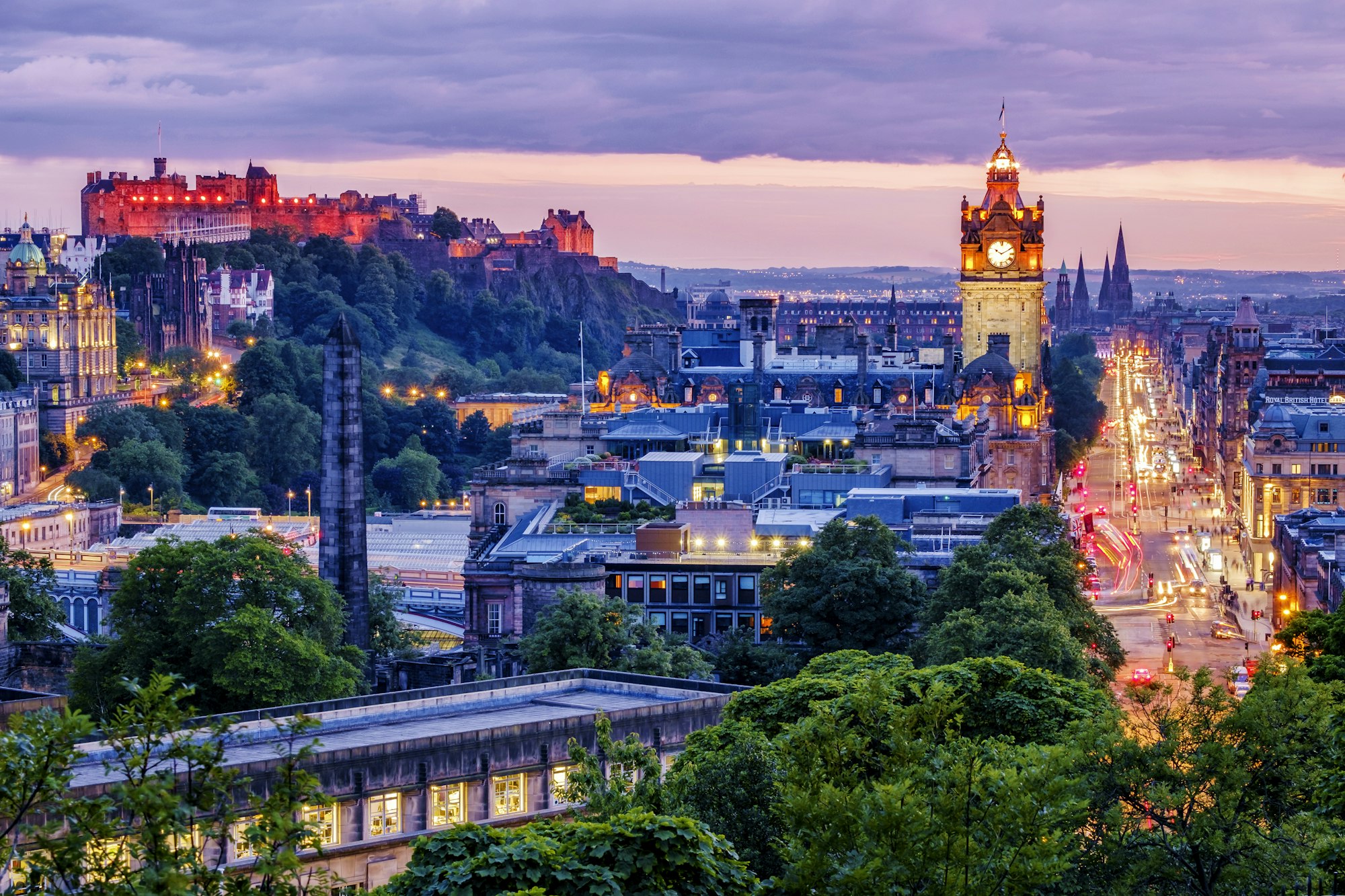 Edinburgh skyline lit up at dawn.